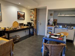 a kitchen with a blue table and a counter top at La Ligne in Angles-sur-lʼAnglin