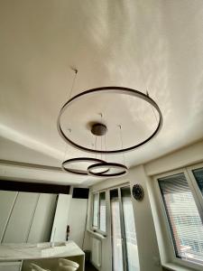 a chandelier hanging from a ceiling in a room at Casa Perini - Luxury Apartment in Trento