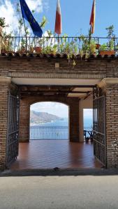 a brick archway with a balcony with a view of the ocean at B&B Casa Michele in Taormina