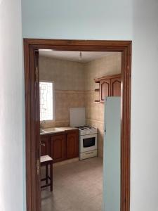 a kitchen with a white refrigerator and a stove at Appartement spacieux, Résidence Les 5 étoiles, Bizerte in Zarzouna