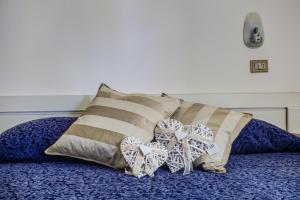 a bed with two pillows on top of it at Hotel Tiziana in Rimini