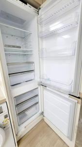 an empty refrigerator with its door open in a kitchen at Oh~Misa! in Changnyemal