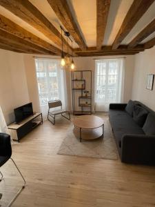 a living room with a couch and a coffee table at Charmant appartement Orléans ! in Orléans