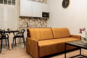 a living room with a couch and a kitchen at VacationClub - Old Town Apartament 8B in Kłodzko