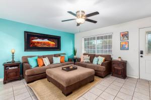 a living room with a couch and a ceiling fan at Cozy Tempe Casa with Heated Pool 5 Minutes to ASU in Tempe