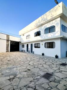 a white building with a large stone driveway at Casa Blanca in Comitán