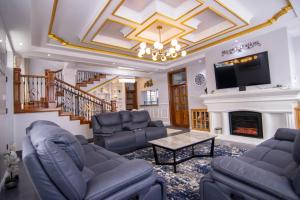 a living room with couches and a fireplace at Cadenrockvilla - Furnished 3 bedroom villa with pool in Ruiru