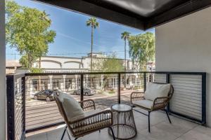 a balcony with two chairs and a view of a street at LUX at Craftsman - Heart of Old Town Studio 1 in Scottsdale