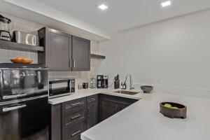 a kitchen with wooden cabinets and a white counter top at LUX at Craftsman - Heart of Old Town Studio 2 in Scottsdale