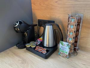 a coffee maker and muffins on a counter at BRIVIBAS RESIDENCE - NORTH & SOUTH, free PRIVAT parking, free WIFI, self check-in in Riga
