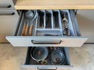 a drawer filled with utensils in a kitchen at BRIVIBAS RESIDENCE - NORTH & SOUTH, free PRIVAT parking, free WIFI, self check-in in Riga