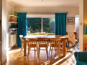 a dining room with a table and chairs at Pass the Keys A home away from home in Cardiff