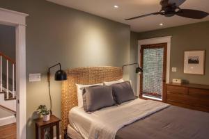 a bedroom with a bed with a fan and a window at Roof Terrace Oasis in Savannah