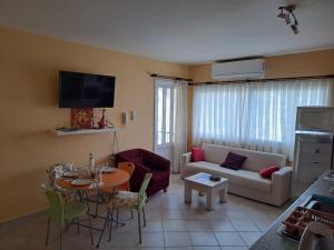 a living room with a couch and a table at Sunrise Beach Club (Hera B6@) in Kalecik