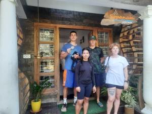 a group of people standing in front of a house at Sopanam Heritage Thekkady in Thekkady