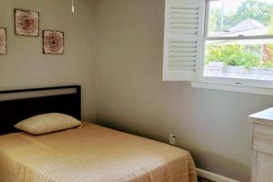 a bedroom with a bed and a window at Historic Haymount House with Tuscan Vibe in Fayetteville