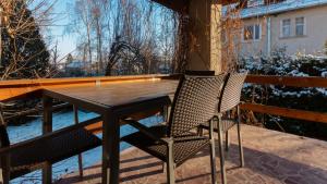 a wooden table and two chairs on a balcony at VacationClub - Cicha 8 Apartament 1 in Polanica-Zdrój