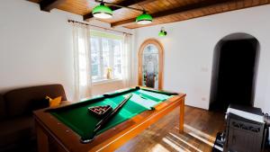 a living room with a pool table in a room at VacationClub - Cicha 8 Apartament 1 in Polanica-Zdrój
