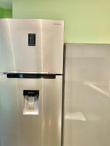 a stainless steel refrigerator with a water dispenser on it at Maison Stylée 98m2 centre bordeaux in Bordeaux