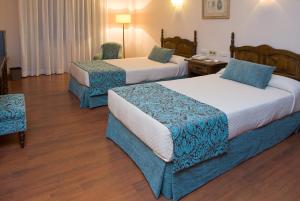 Postel nebo postele na pokoji v ubytování Hotel Pazo O Rial