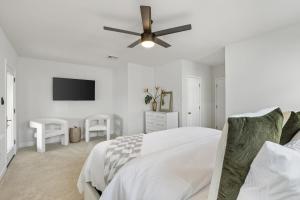 a white bedroom with a bed and a ceiling fan at 3-BR Getaway on the Chesapeake Bay in North Beach