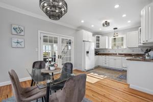 a kitchen with white cabinets and a table and chairs at 3-BR Getaway on the Chesapeake Bay in North Beach