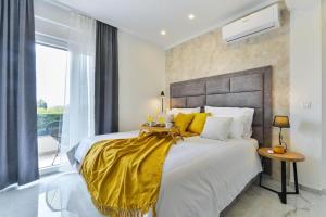 a bedroom with a large bed with a yellow blanket at Holiday home in Bibinje with sea view, balcony, air conditioning, WiFi 5201-1 in Bibinje +67 photos