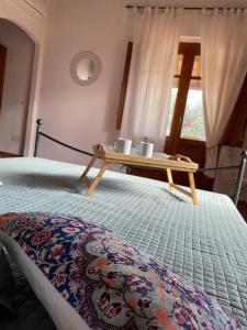 a bed with a wooden tray on top of it at La Vecchia Fornace in SantʼAnna Arresi