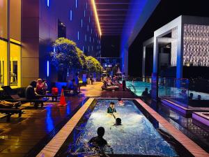 a group of people in a swimming pool in a building at Platinum suites by BLUE SKY in Kuala Lumpur