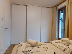 a bedroom with two beds and a window at Apartmány NETA Velké Karlovice, Polanský Dvůr in Velké Karlovice