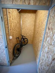 a bike in a small room with a wall at Apartmány NETA Velké Karlovice, Polanský Dvůr in Velké Karlovice