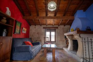 a living room with a couch and a fireplace at Casa Rural Aldaba in Alcalá del Júcar