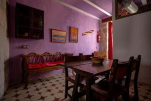 a dining room with a table and chairs and a couch at Casa Rural Aldaba in Alcalá del Júcar +7 photos