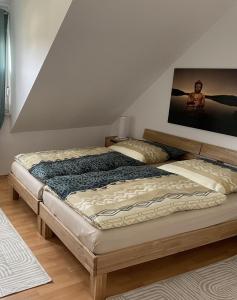 a bed in a bedroom with a painting on the wall at Noras Ferienwohnung 