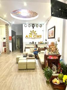 a living room with a person sitting on a couch at Khách Sạn An Chi in Ho Chi Minh City
