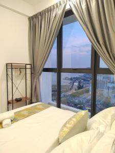 1 dormitorio con cama y ventana grande en Seaview Infinity Pool/ 40th/ 10pax/ 3Rooms 2Carpark, en Jelutong
