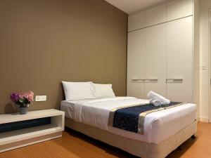 a bedroom with a bed and a cabinet at Platinum suites by BLUE SKY in Kuala Lumpur