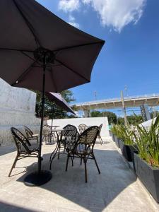 a table and chairs with an umbrella on a patio at Casa Zapopan Hotel in Guadalajara