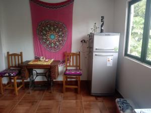 a kitchen with a table and a refrigerator at Amplio monoambiente in Paraná