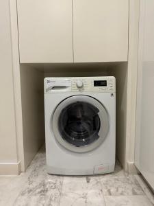 a white washer and dryer sitting in a room at Platinum suites by BLUE SKY in Kuala Lumpur
