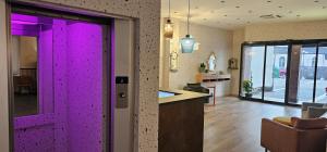 a purple door in a room with a kitchen at Hotel La Superba in Genova