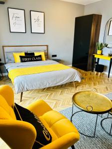 a bedroom with a bed and a couch and a table at Capital Towers "FIRST CLASS" in Rzeszów