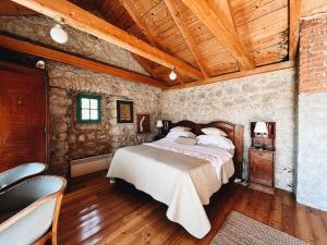 a bedroom with a large bed in a stone wall at Authentic Stone House Tranquil Villa for Families and Groups in Grižane +20 photos