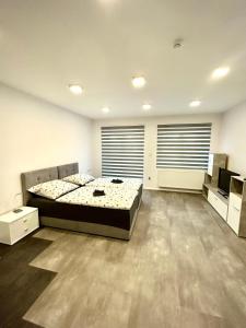 A bed or beds in a room at Apartmány PREMIUM se soukromým parkováním