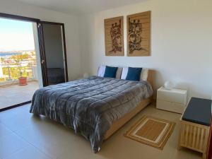 a bedroom with a large bed and a balcony at Penthouse Le Isole in Marsala