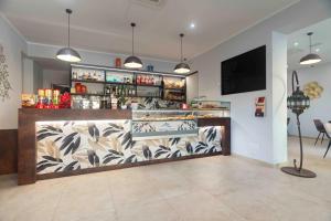 a bar in a room with a counter with drinks at Montecristo B&B in Grosseto