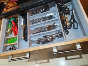 a drawer full of utensils in a kitchen at Glencolmcille Spectacular Views in Glencolumbkille