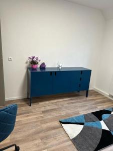 a blue dresser in a living room with at Villa Schloßblick-Schwarzenberg in Neuanbau