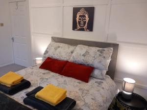 a bedroom with a bed with two pillows on it at Springfield Apartment - Train to Glasgow or Edinburgh - Private Parking & Wifi in Airdrie