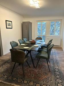 a dining room with a table and chairs at Villa Schloßblick-Schwarzenberg in Neuanbau